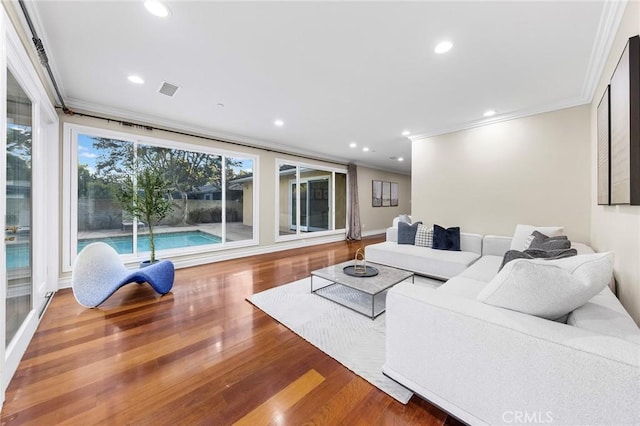 living room featuring wood-type flooring and ornamental molding