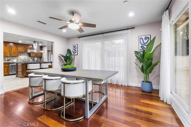 dining area featuring ceiling fan and hardwood / wood-style floors