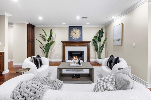 living room with dark wood-type flooring and ornamental molding