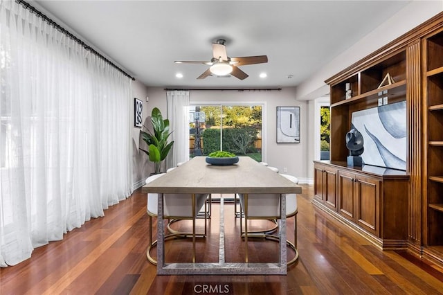 dining area with ceiling fan and dark wood-type flooring