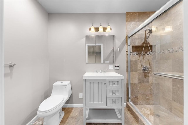 bathroom with toilet, walk in shower, and vanity