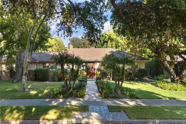 ranch-style home with a front lawn