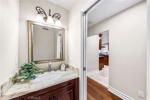 bathroom with hardwood / wood-style flooring and vanity