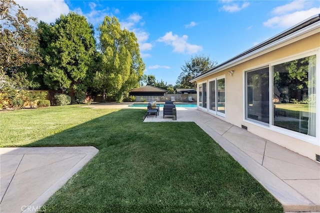 view of yard featuring a patio area and a fenced in pool