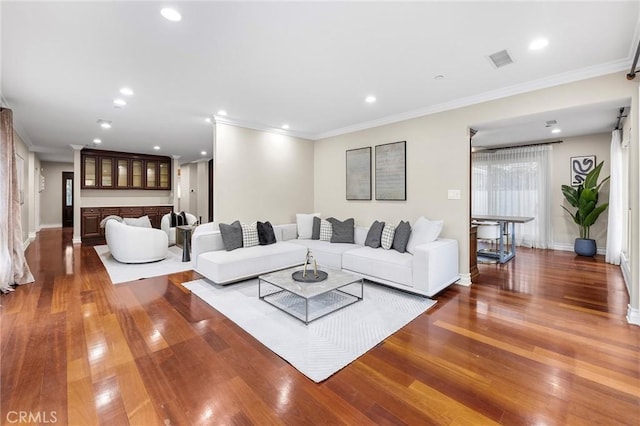 living room featuring ornamental molding, a fireplace, and hardwood / wood-style floors