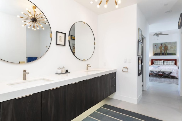 bathroom with ceiling fan with notable chandelier, tile patterned floors, and vanity