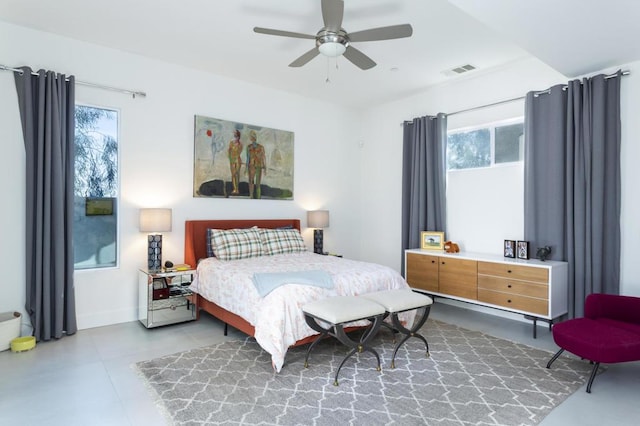 bedroom with ceiling fan and multiple windows