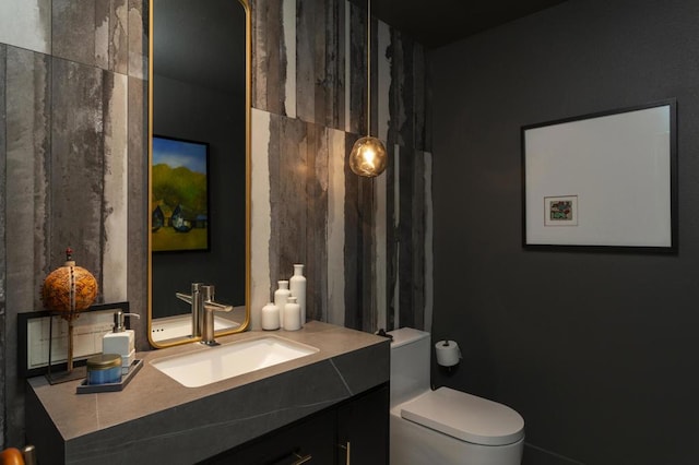 bathroom featuring toilet and vanity