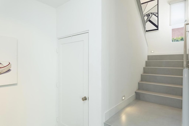 stairway with concrete flooring