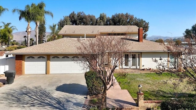 view of property with a garage and a mountain view