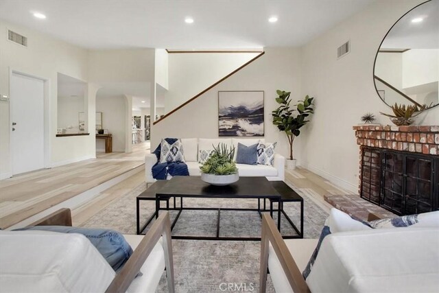 living room with wood-type flooring and a fireplace