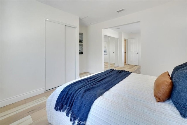 bedroom featuring a closet and light hardwood / wood-style flooring