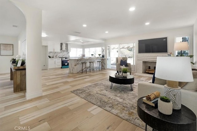 living room with a fireplace and light hardwood / wood-style floors