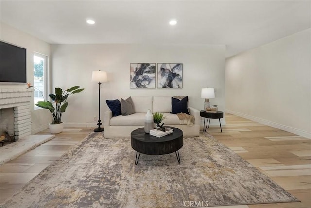 living room with a fireplace and light hardwood / wood-style floors