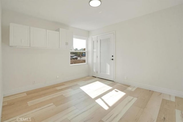 spare room featuring light wood-type flooring