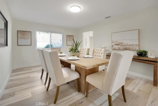 dining area with light hardwood / wood-style floors