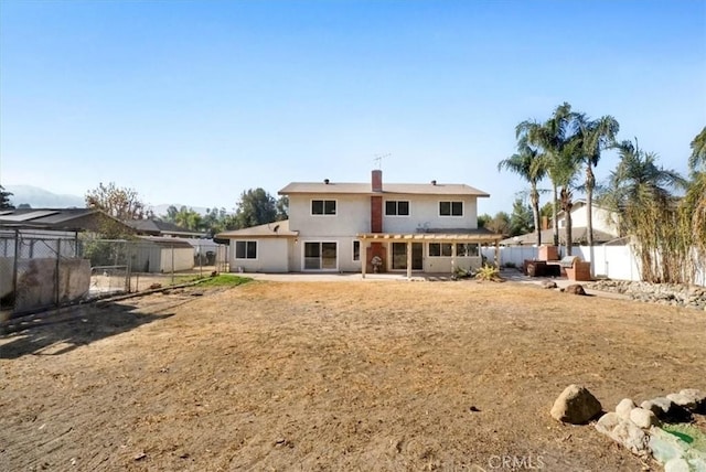 rear view of property featuring a patio area