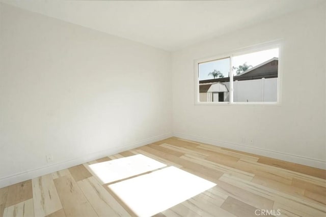 unfurnished room with light hardwood / wood-style flooring