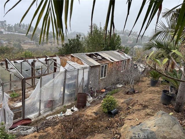 view of home's exterior featuring an outbuilding and an exterior structure