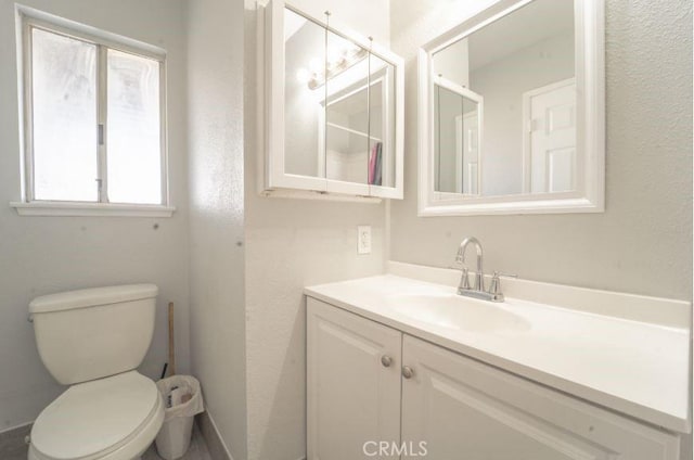 bathroom featuring toilet and vanity