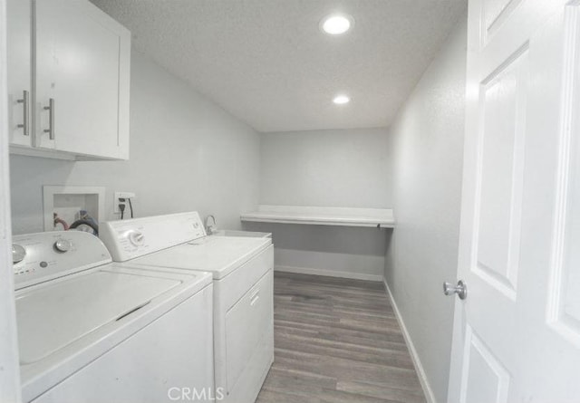 laundry area with dark wood-type flooring, a textured ceiling, and independent washer and dryer