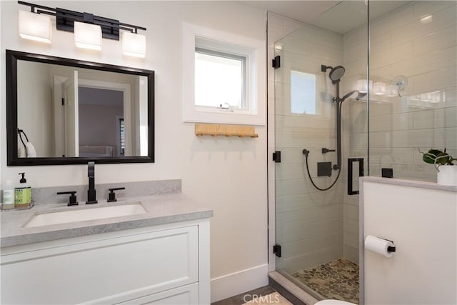 bathroom featuring vanity and a shower with door