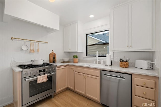 kitchen featuring white cabinets, light wood-type flooring, sink, and stainless steel appliances