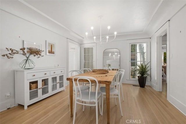 dining room featuring light hardwood / wood-style flooring and a chandelier