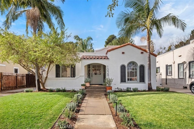 mediterranean / spanish-style house featuring a front yard