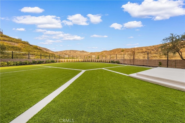 view of yard with a rural view and a mountain view