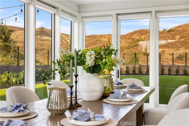 sunroom featuring a mountain view