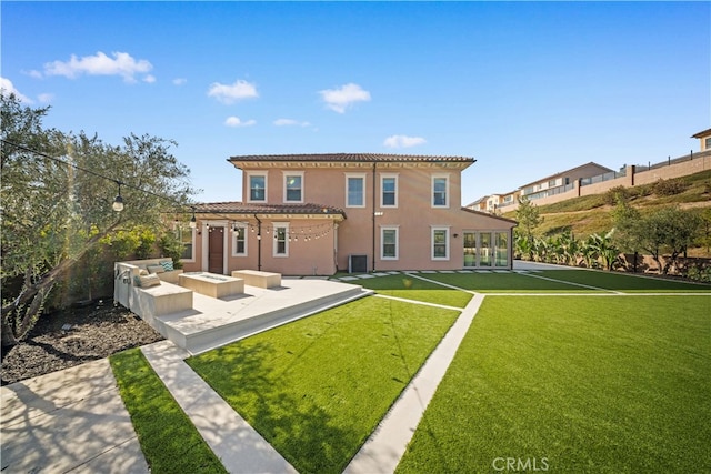 back of property featuring a pergola, a lawn, a patio, and an outdoor fire pit