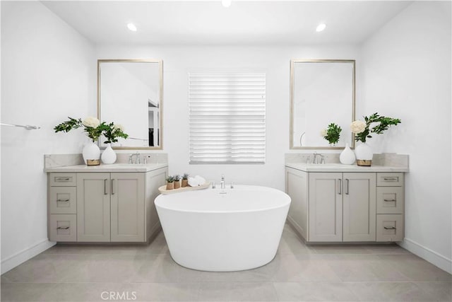 bathroom featuring tile patterned floors, a tub to relax in, and vanity