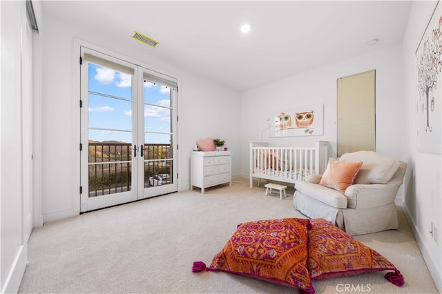 carpeted bedroom with french doors and access to exterior