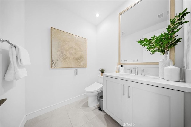 bathroom featuring vanity, tile patterned floors, and toilet