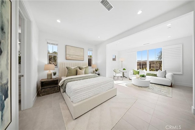 tiled bedroom featuring multiple windows