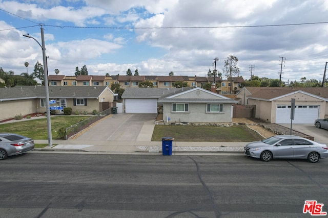 single story home featuring a front yard and a garage