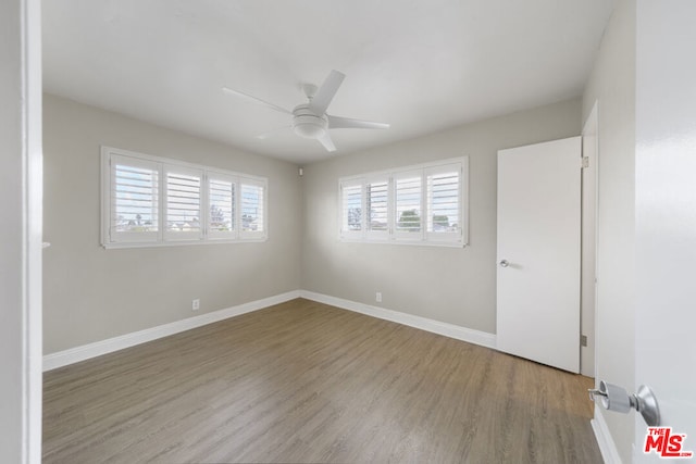 unfurnished room with ceiling fan and hardwood / wood-style floors