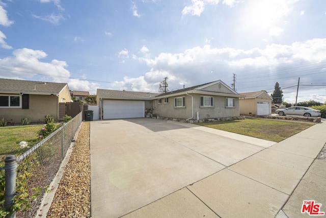 ranch-style home featuring a garage and a front lawn