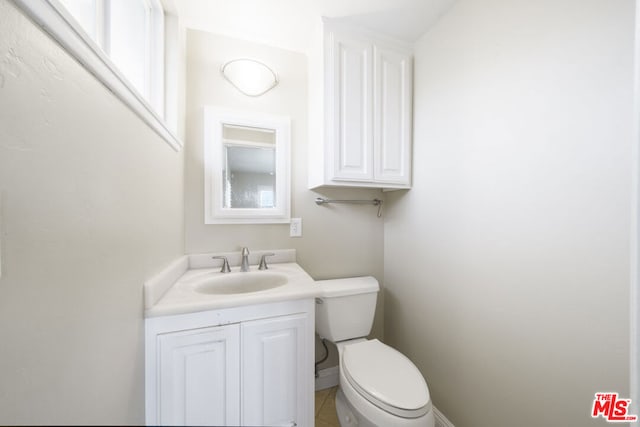 bathroom featuring toilet and vanity