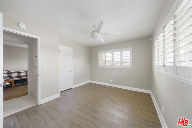 empty room featuring ceiling fan and wood-type flooring