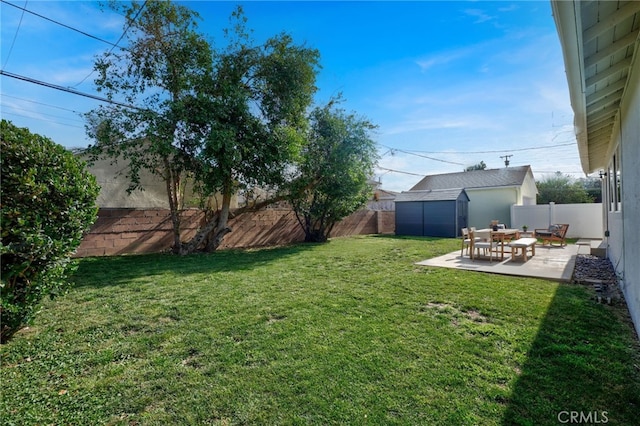 view of yard with a storage shed and a patio