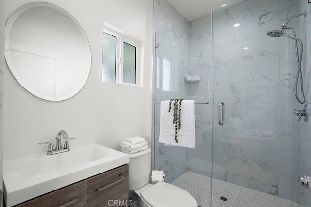 bathroom with an enclosed shower, vanity, and toilet