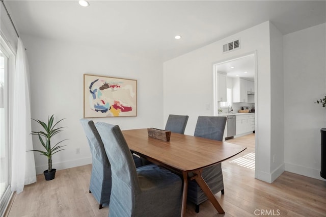 dining space with light wood-type flooring