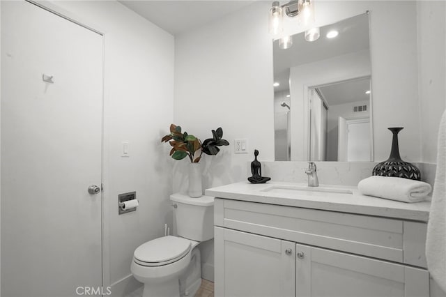 bathroom featuring toilet and vanity