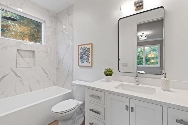 full bathroom with vanity, toilet, and tiled shower / bath combo