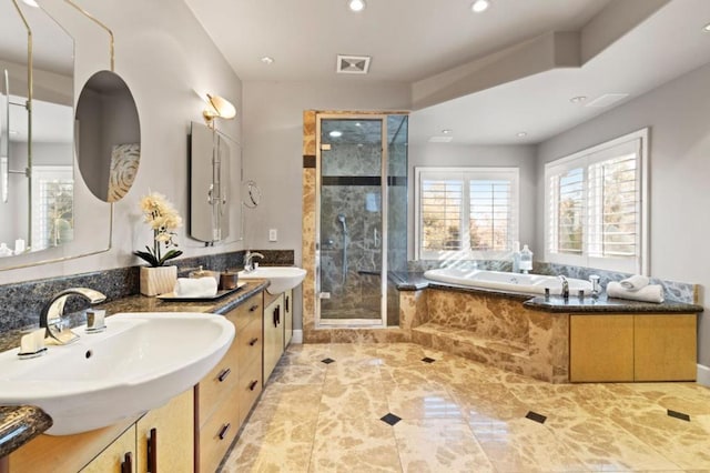 bathroom featuring shower with separate bathtub and vanity