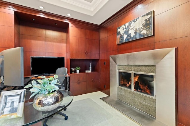 home office with a tiled fireplace and ornamental molding