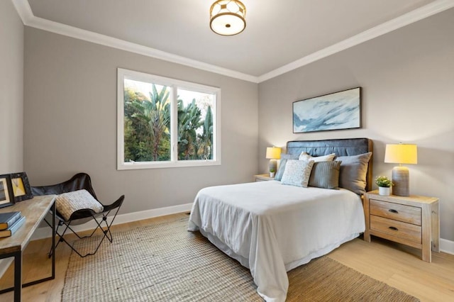 bedroom featuring ornamental molding and light wood-type flooring