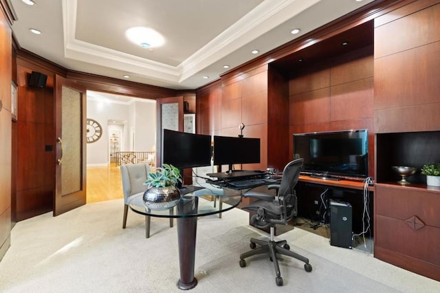 carpeted office space with a raised ceiling and crown molding